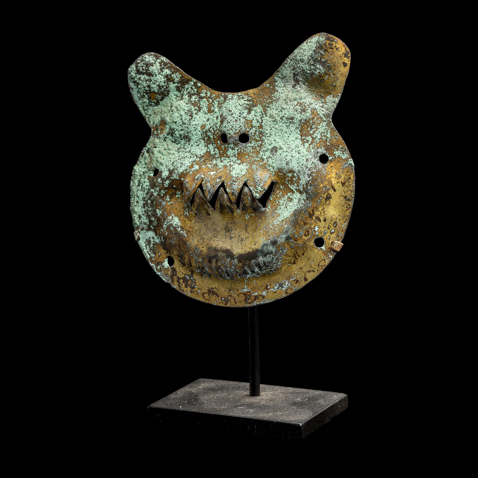 A Vicus Copper Gilt Feline Head Pendant