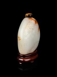 A Chinese White and Russet Jade Pebble-Form Snuff Bottle