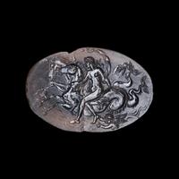 A Roman Smokey Quartz Intaglio with a Nereid Riding Two Hippocamps