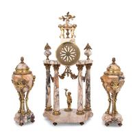 A Louis XVI Style Gilt Metal Mounted Marble Clock Garniture