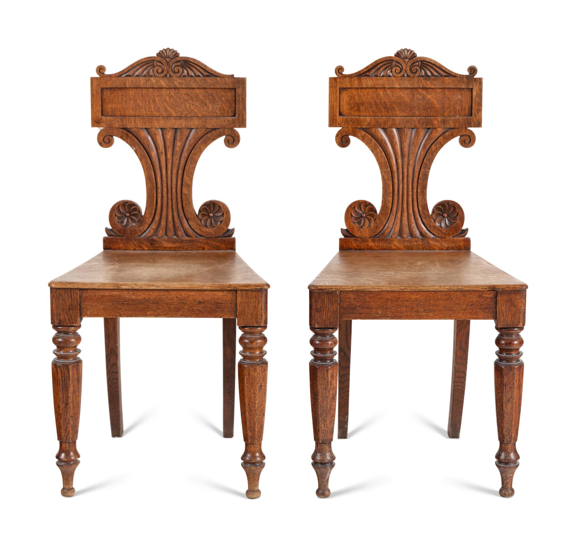 A Pair of William IV Carved Oak Hall Chairs
