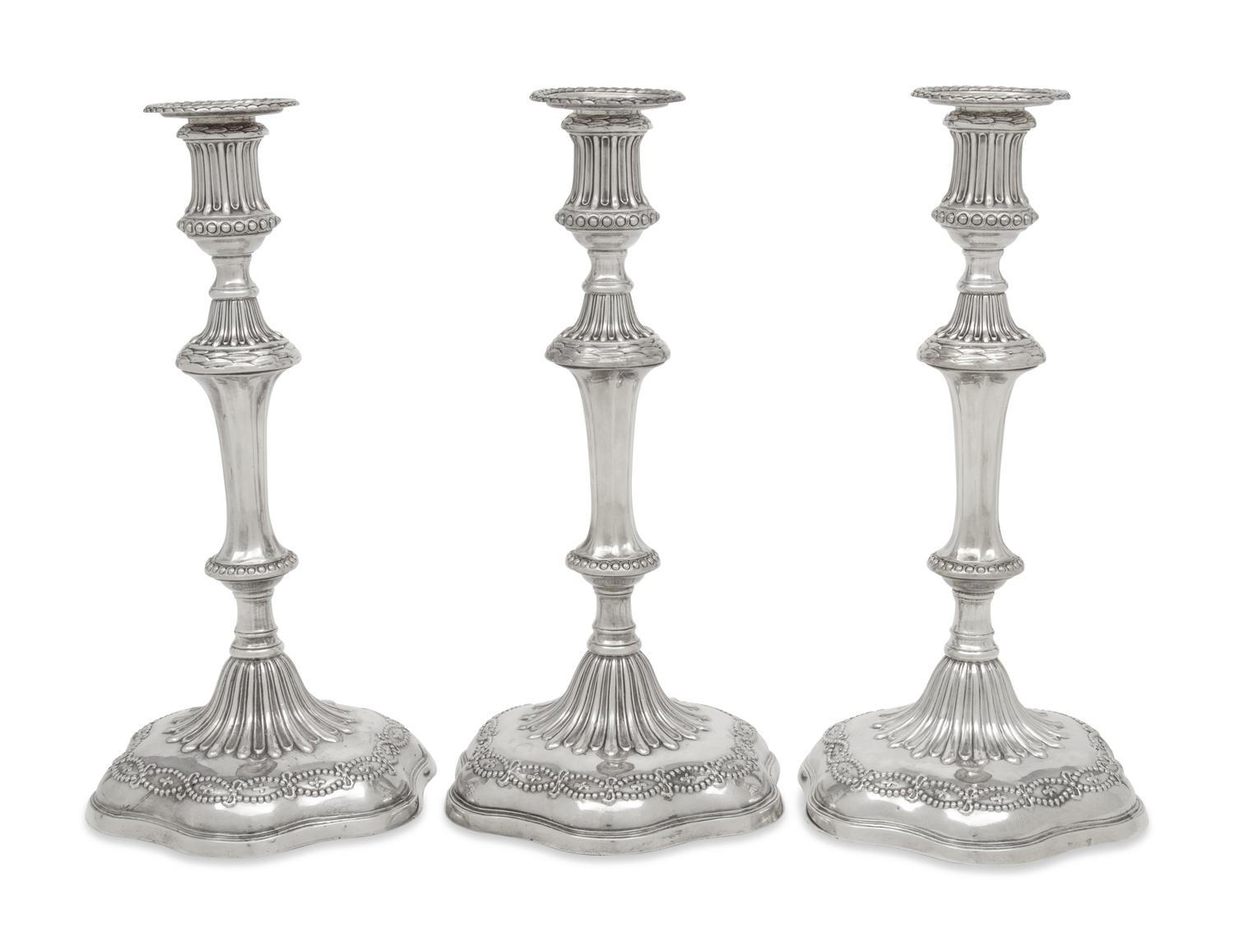 A Set of Three George III Silver Candlesticks