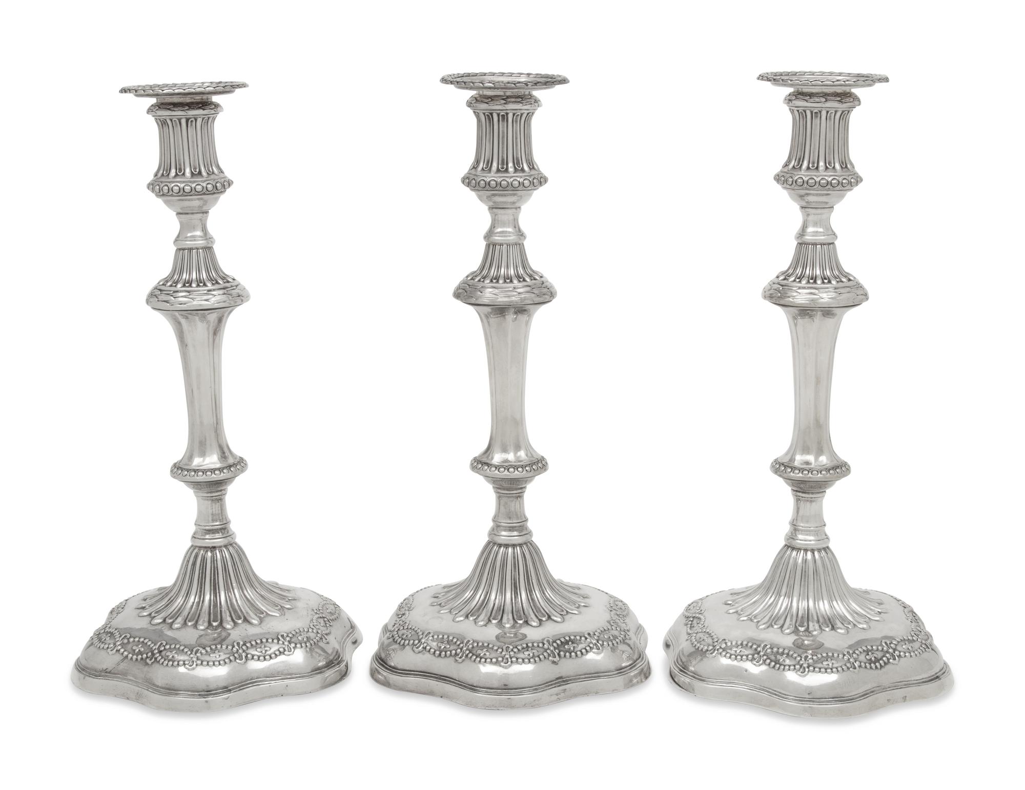 A Set of Three George III Silver Candlesticks