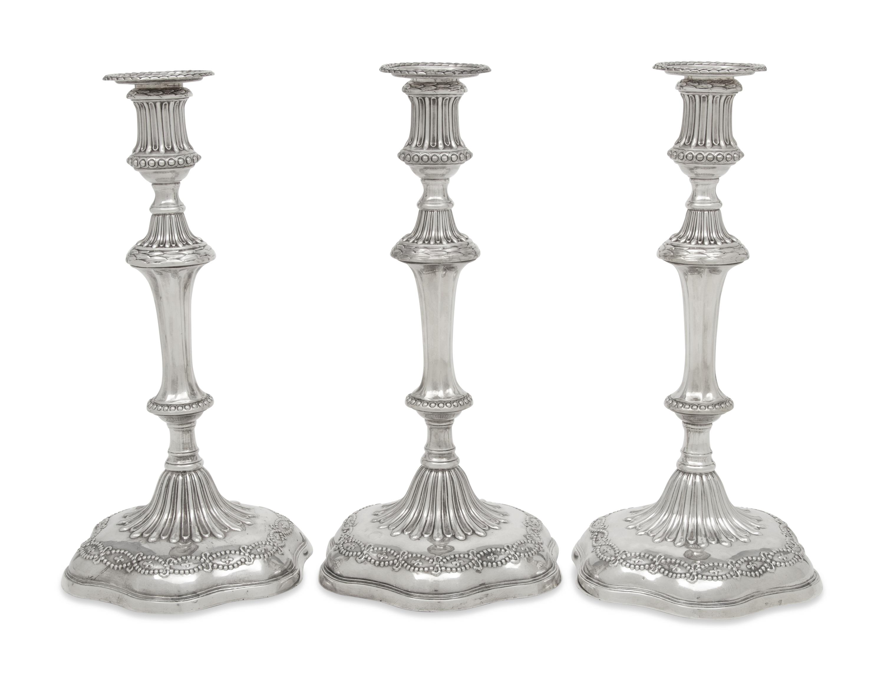 A Set of Three George III Silver Candlesticks