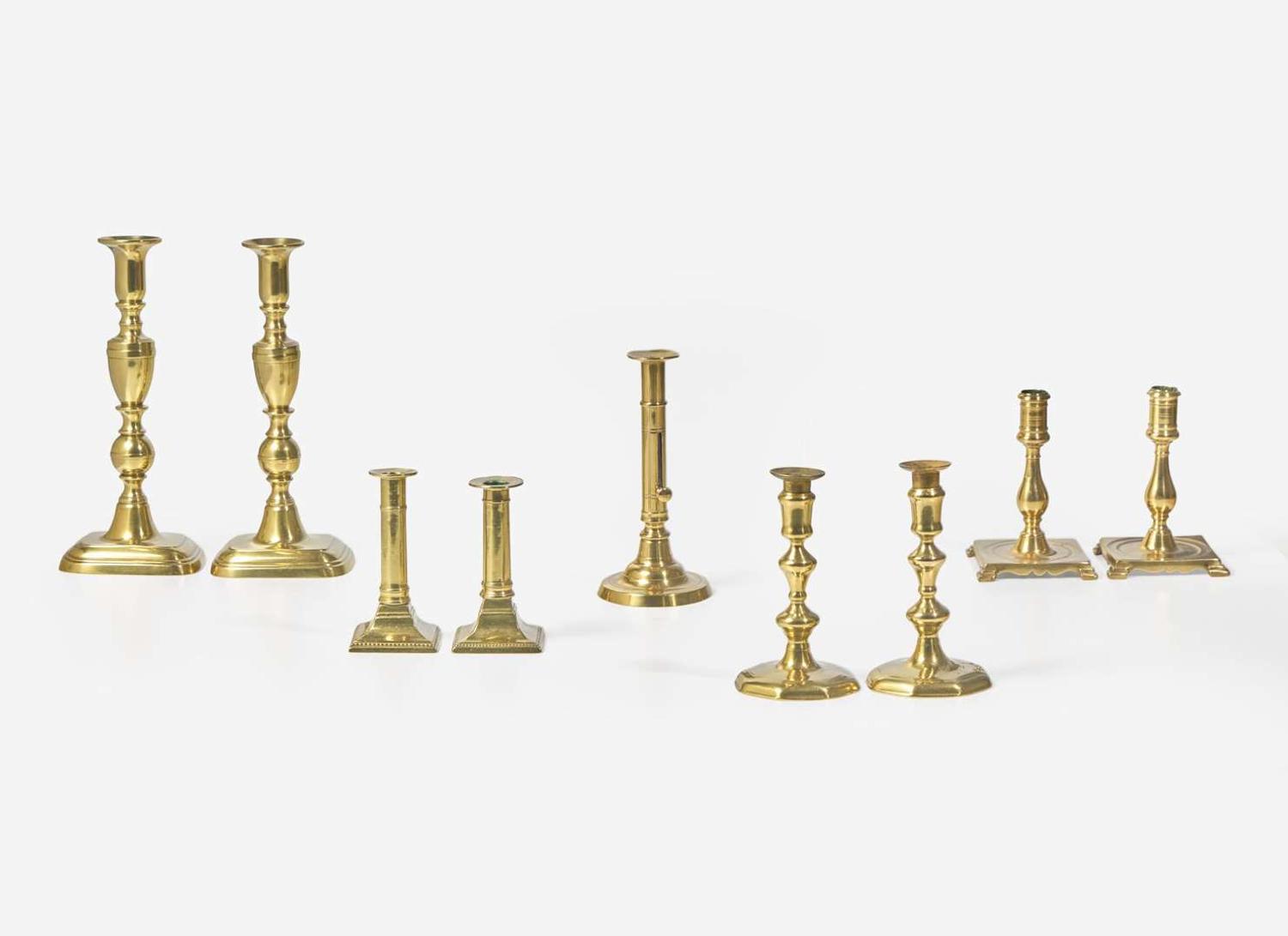 A collection of nine brass candlesticks, primarily English, 17th - 19th century