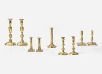 A collection of nine brass candlesticks, primarily English, 17th - 19th century