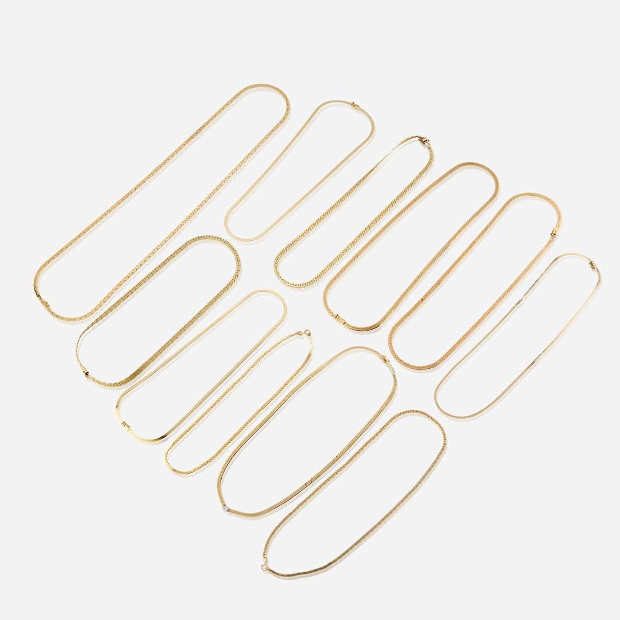 A collection of eleven fourteen karat gold necklaces