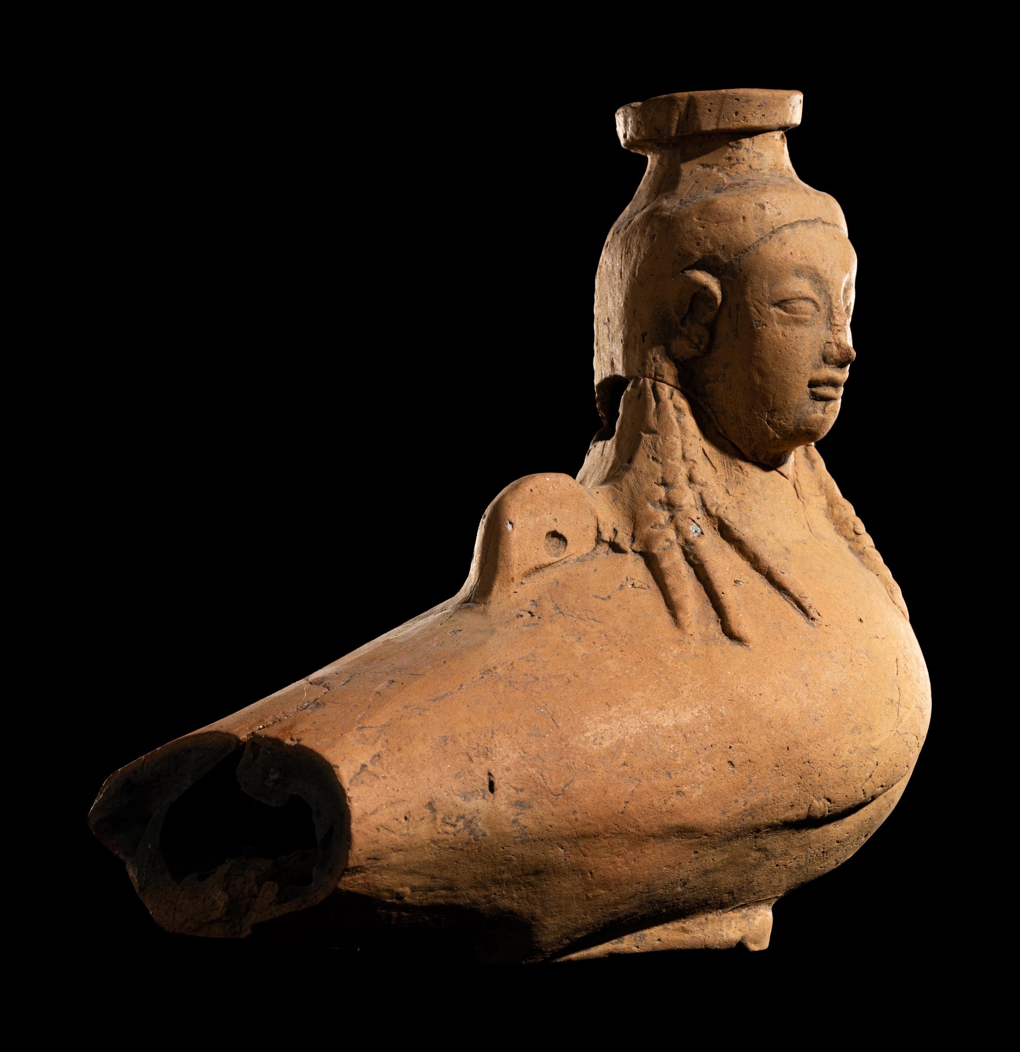 A Rhodian Pottery Figural Vessel in the Form of a Siren