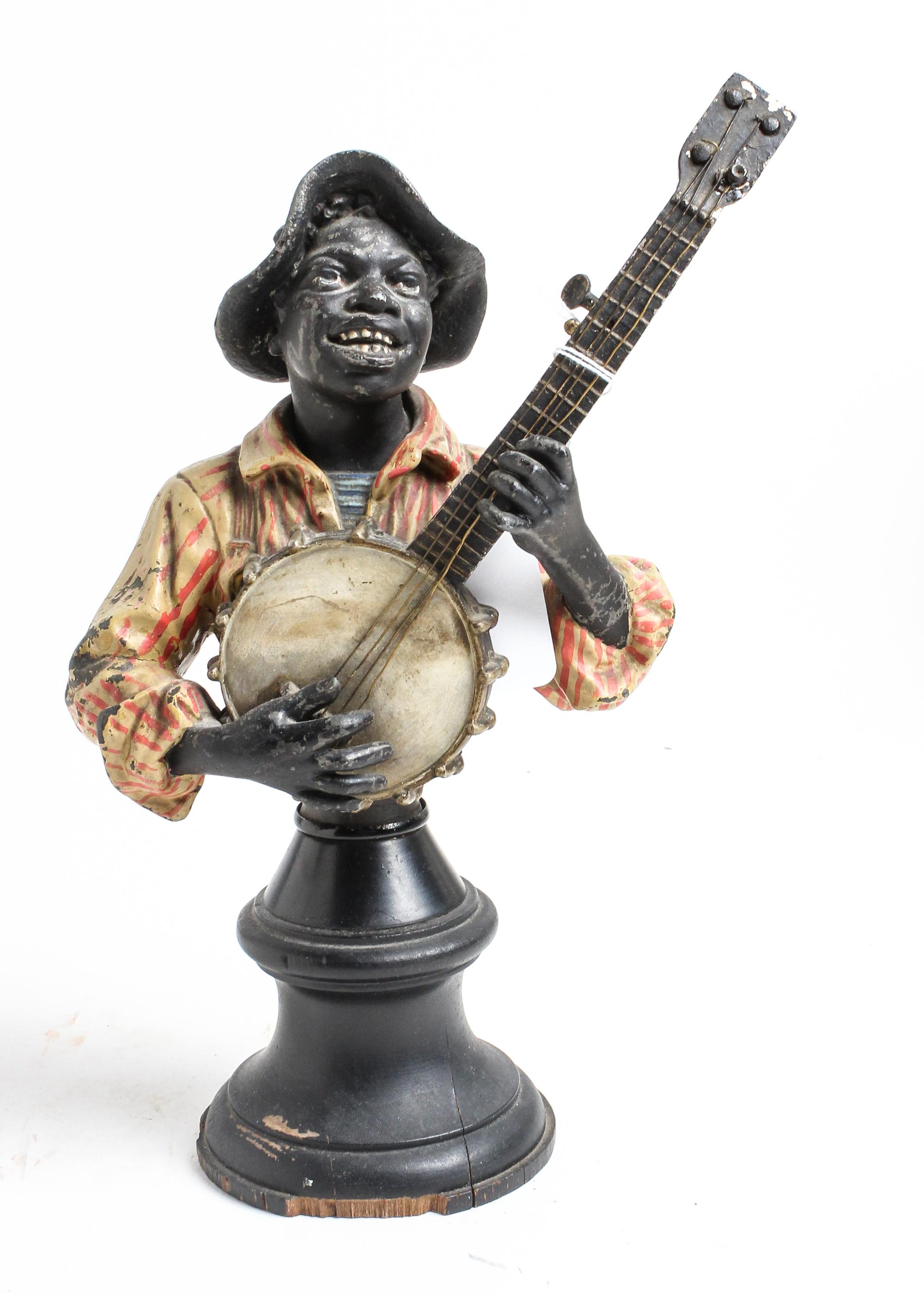 A Painted Cast Metal Bust of a Banjo Player Height 10 3/4 inches. — 19TH CENTURY