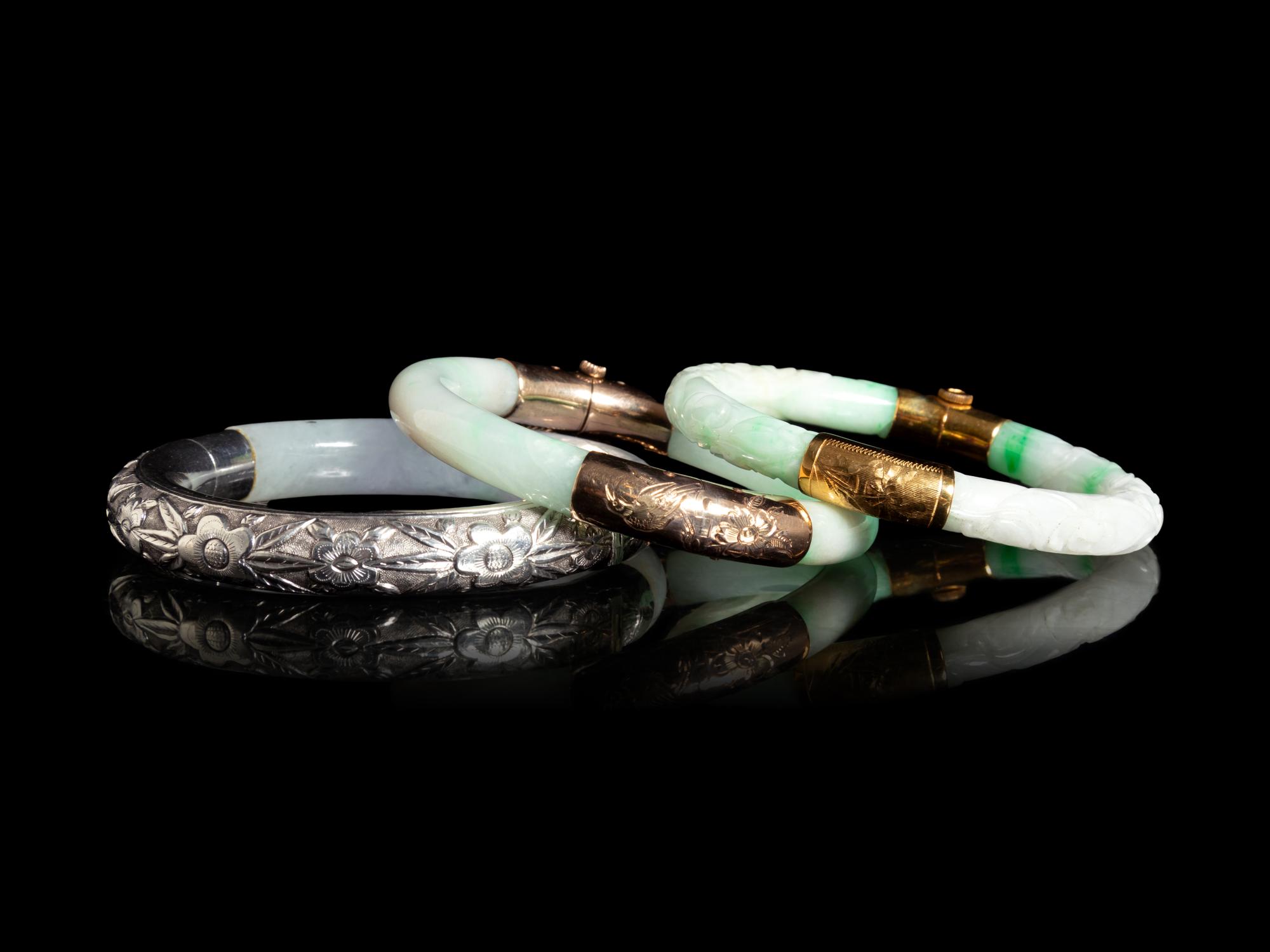 Three Chinese Silver and 14K Yellow Gold Jadeite Bangles