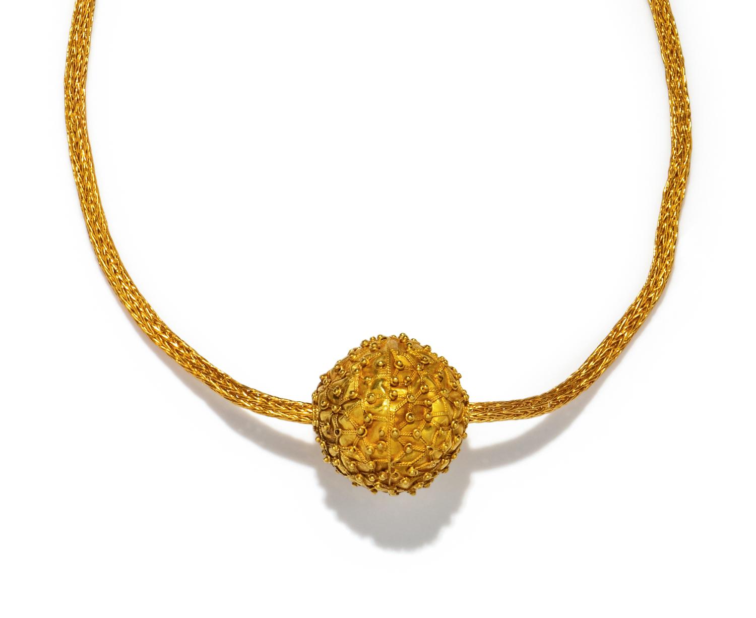 An Islamic Gold Bead — with a gold chain