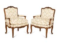 A Pair of Louis XV Style Carved Mahogany Fauteuils