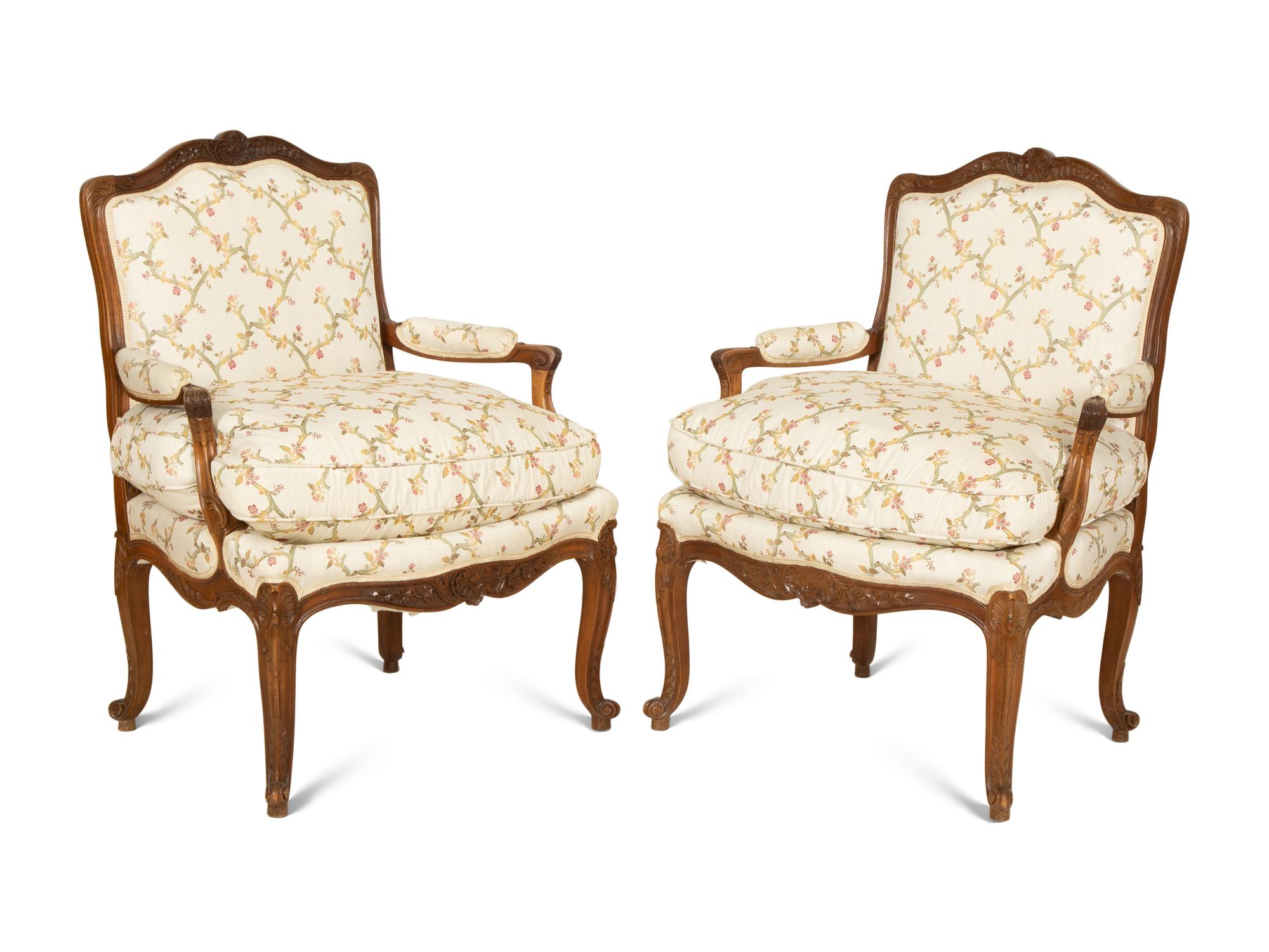 A Pair of Louis XV Style Carved Mahogany Fauteuils