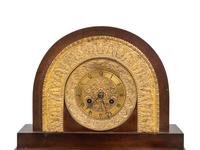 A Charles X Gilt and Patinated Bronze and Mirrored Glass Mantel Clock