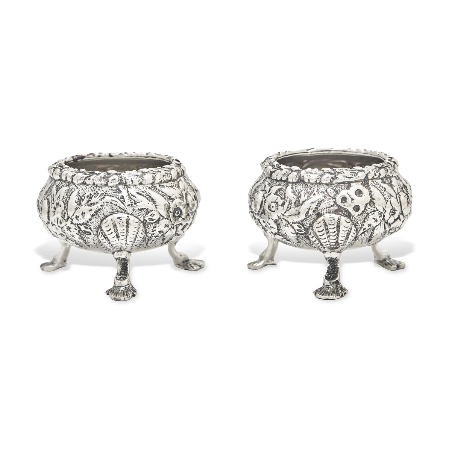 A Pair of Sterling Silver Floral Repousse Salt Cellars