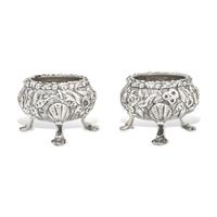 A Pair of Sterling Silver Floral Repousse Salt Cellars