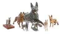 A Group of Seven Metal German Shepherd Figures Width of widest 19 3/4 inches.