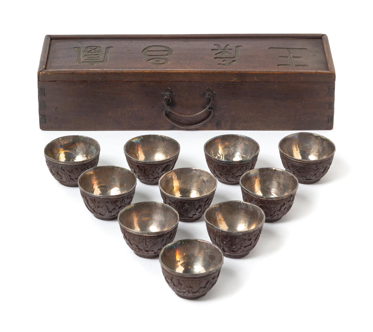 A Set of Ten Chinese Carved Coconut Shell Wine Cups 19TH CENTURY Length of box 12 1/8 x diameter of cup 2 1/8 inches. — 19TH CENTURY