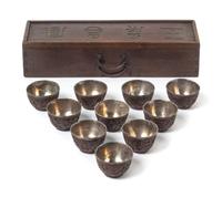 A Set of Ten Chinese Carved Coconut Shell Wine Cups 19TH CENTURY Length of box 12 1/8 x diameter of cup 2 1/8 inches. — 19TH CENTURY