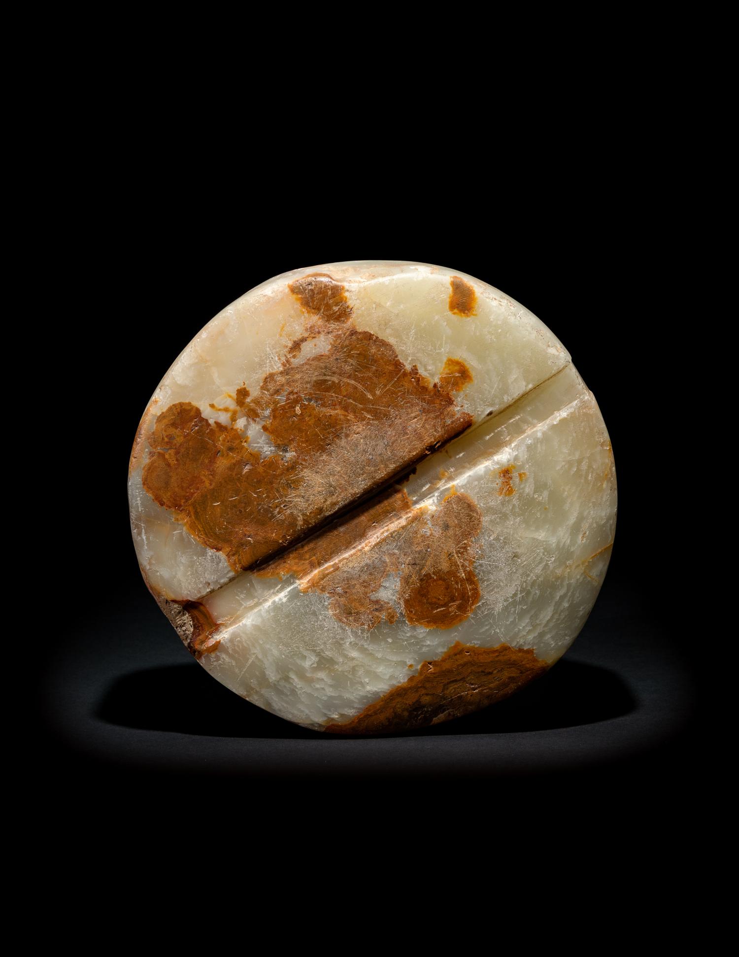 A Bactrian Mottled Green-Orange Stone Disk Ritual Object