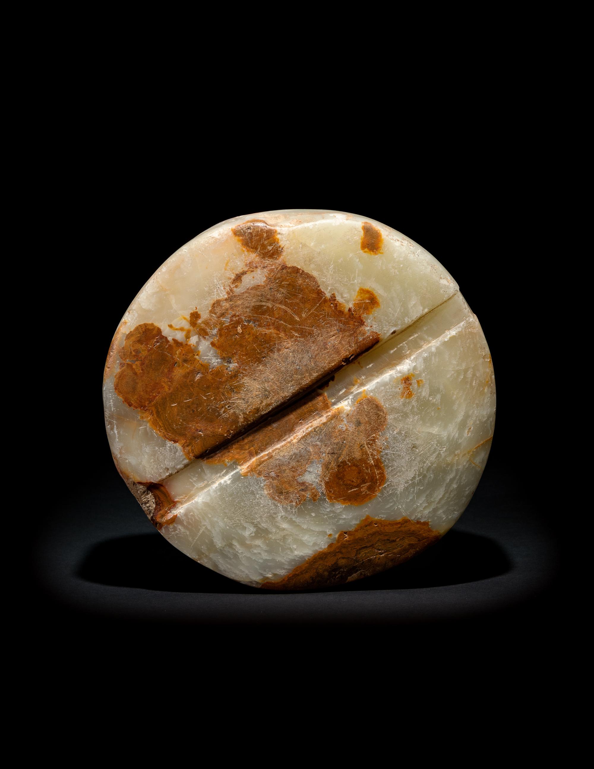 A Bactrian Mottled Green-Orange Stone Disk Ritual Object