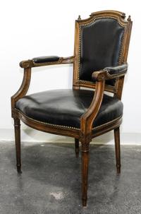 A Leather Upholstered Open Armchair Height 38 inches. — 20TH CENTURY