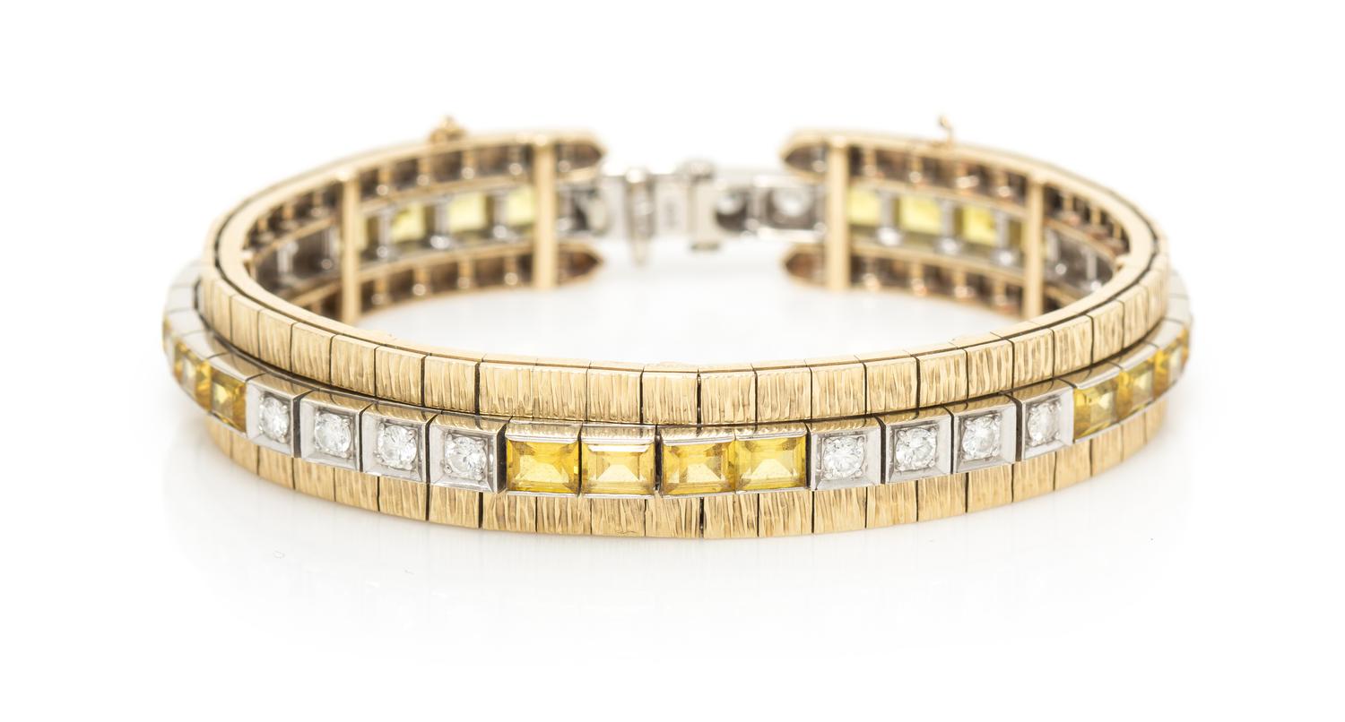 A 14 Karat White Gold, Diamond and Synthetic Yellow Sapphire Line Bracelet with Yellow Gold Bracelet Jacket, 23.30 dwts.