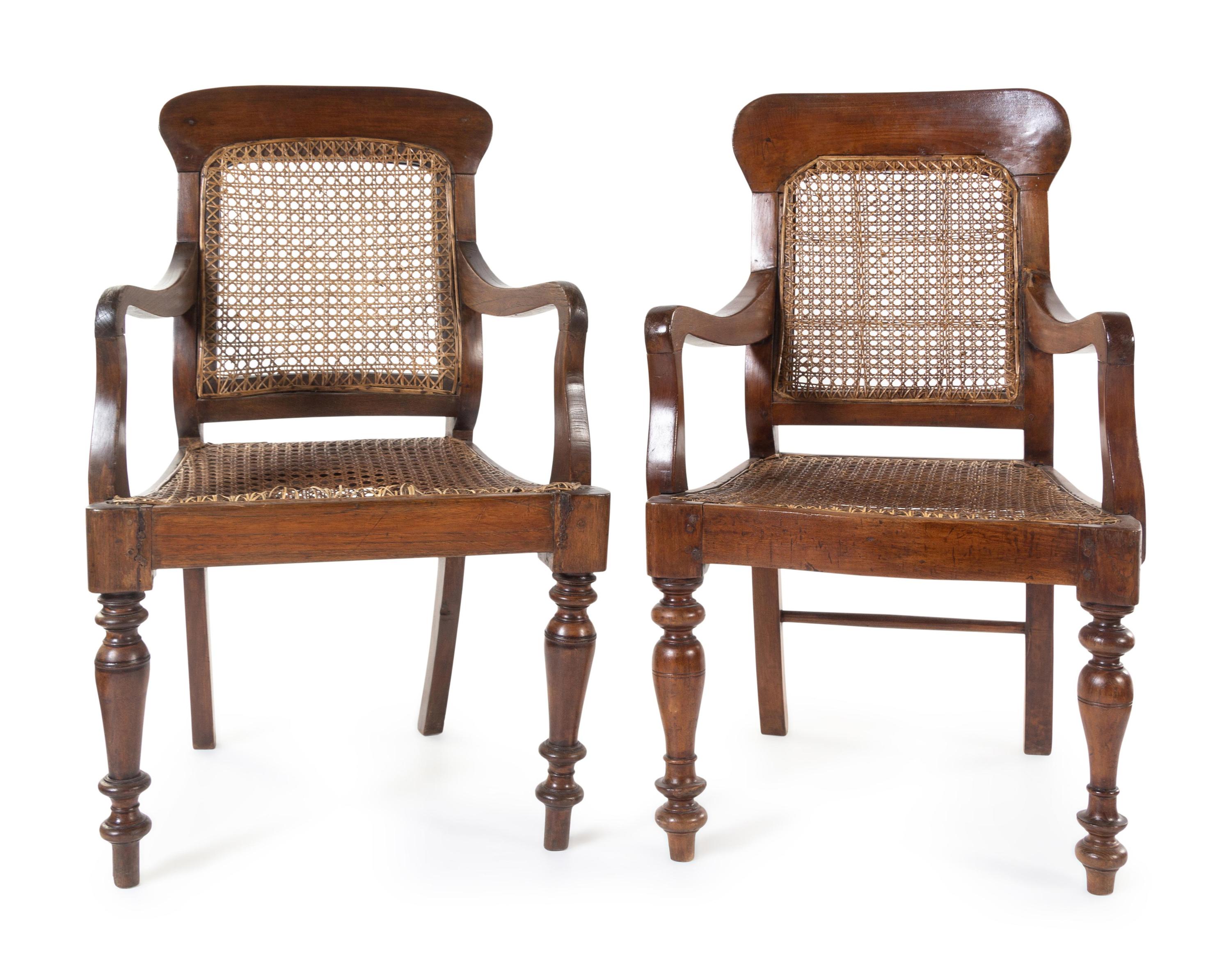 A Near Pair of Anglo-Colonial Teak Armchairs