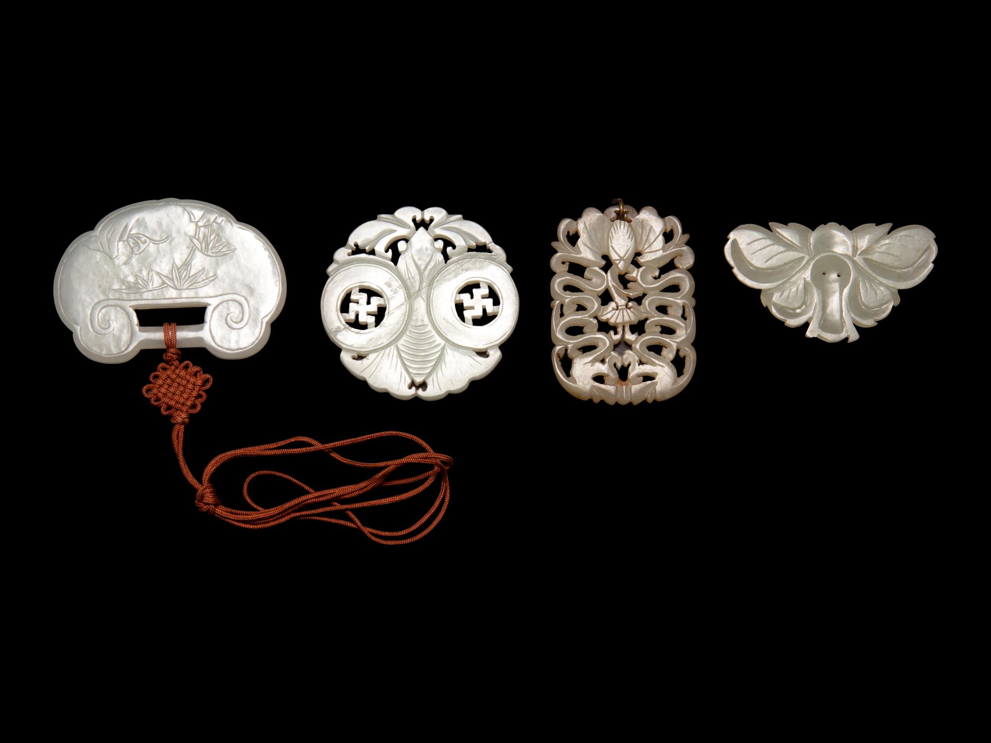 Four Chinese Pale Celadon Jade Pendants