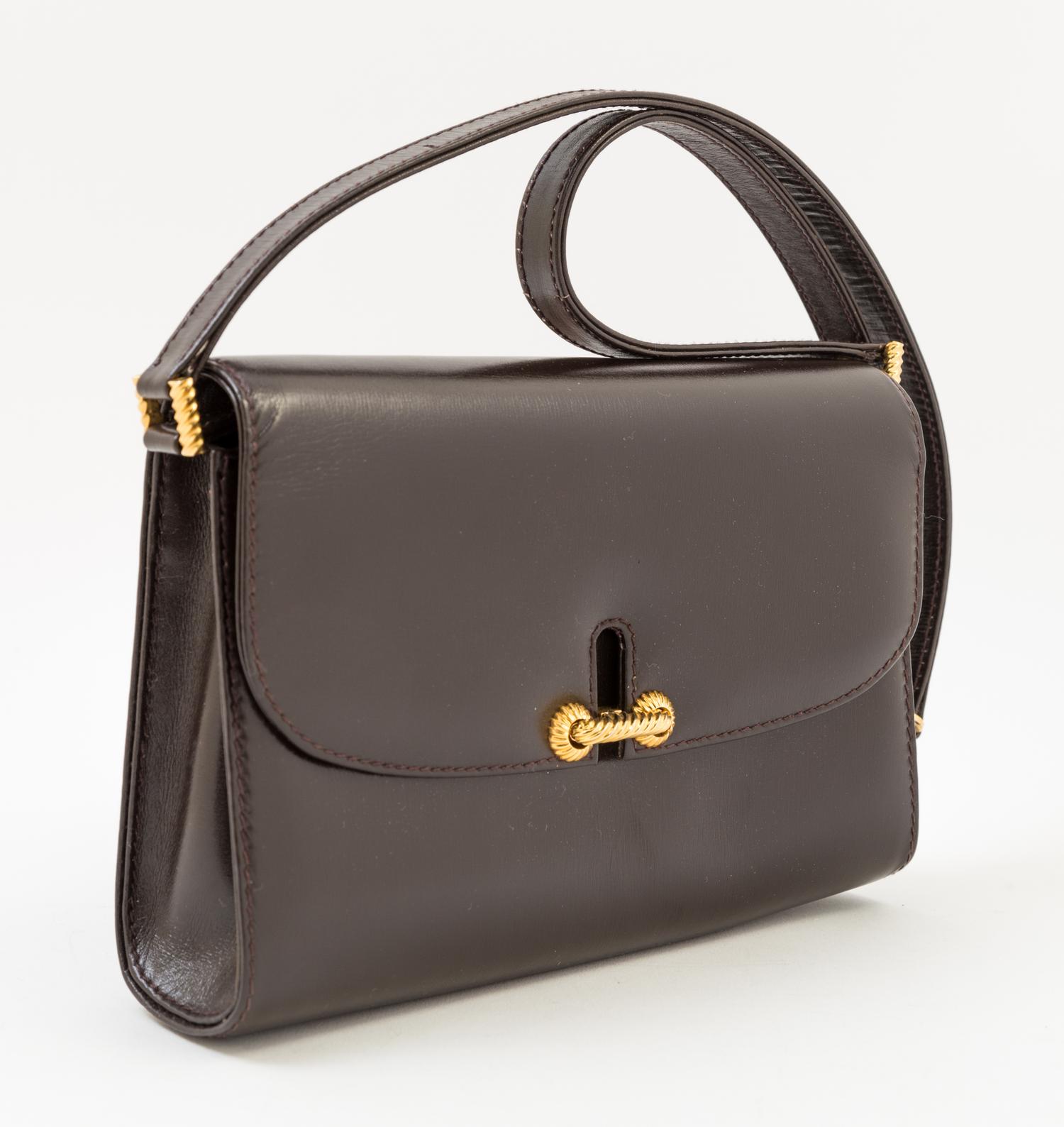 A Gucci Dark Brown Leather Flap Handbag, 8" x 6" x 2"; Strap drop: 14".