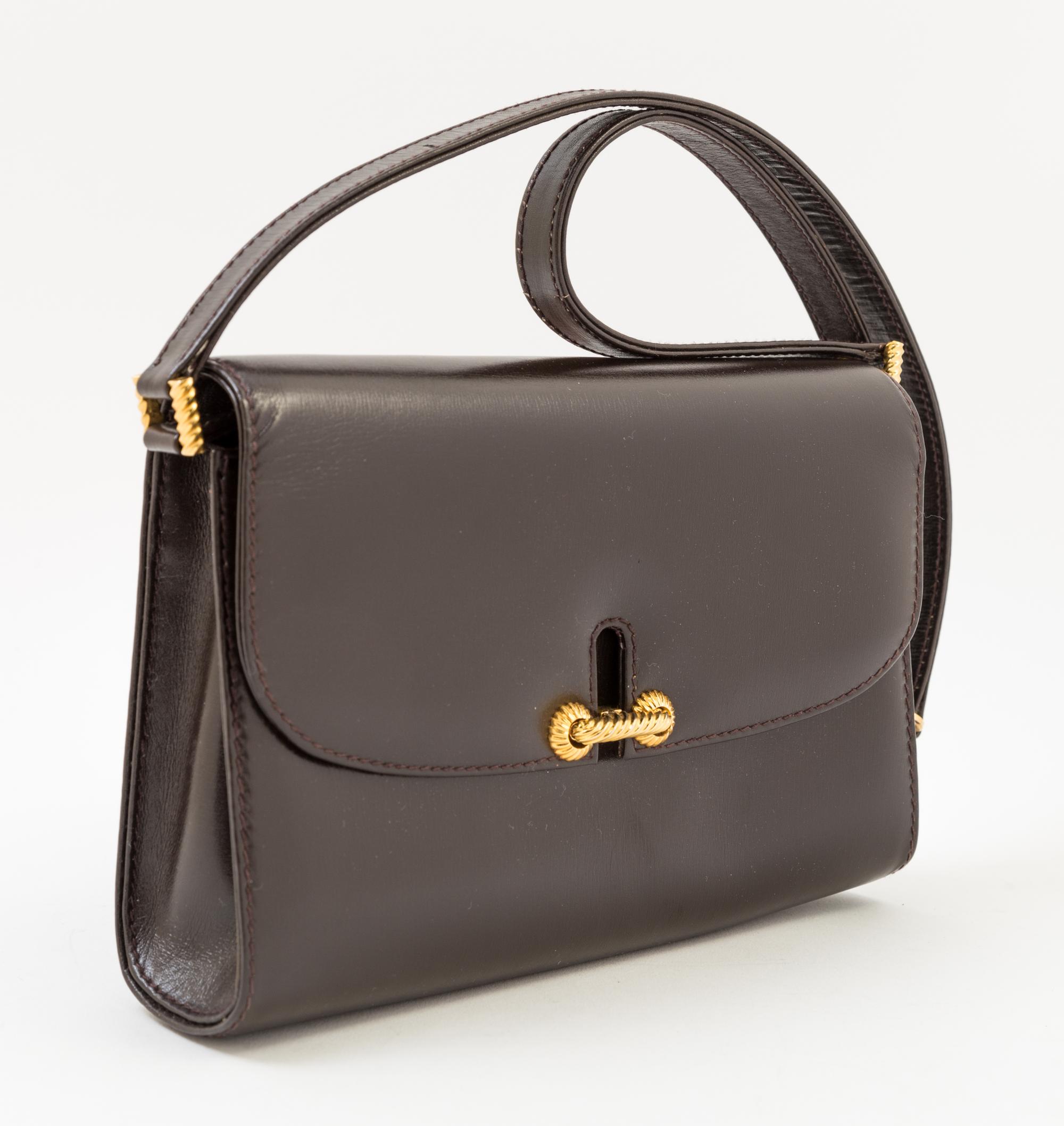 A Gucci Dark Brown Leather Flap Handbag, 8" x 6" x 2"; Strap drop: 14".