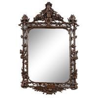 A Swiss "Black Forest" Carved Oak Mirror