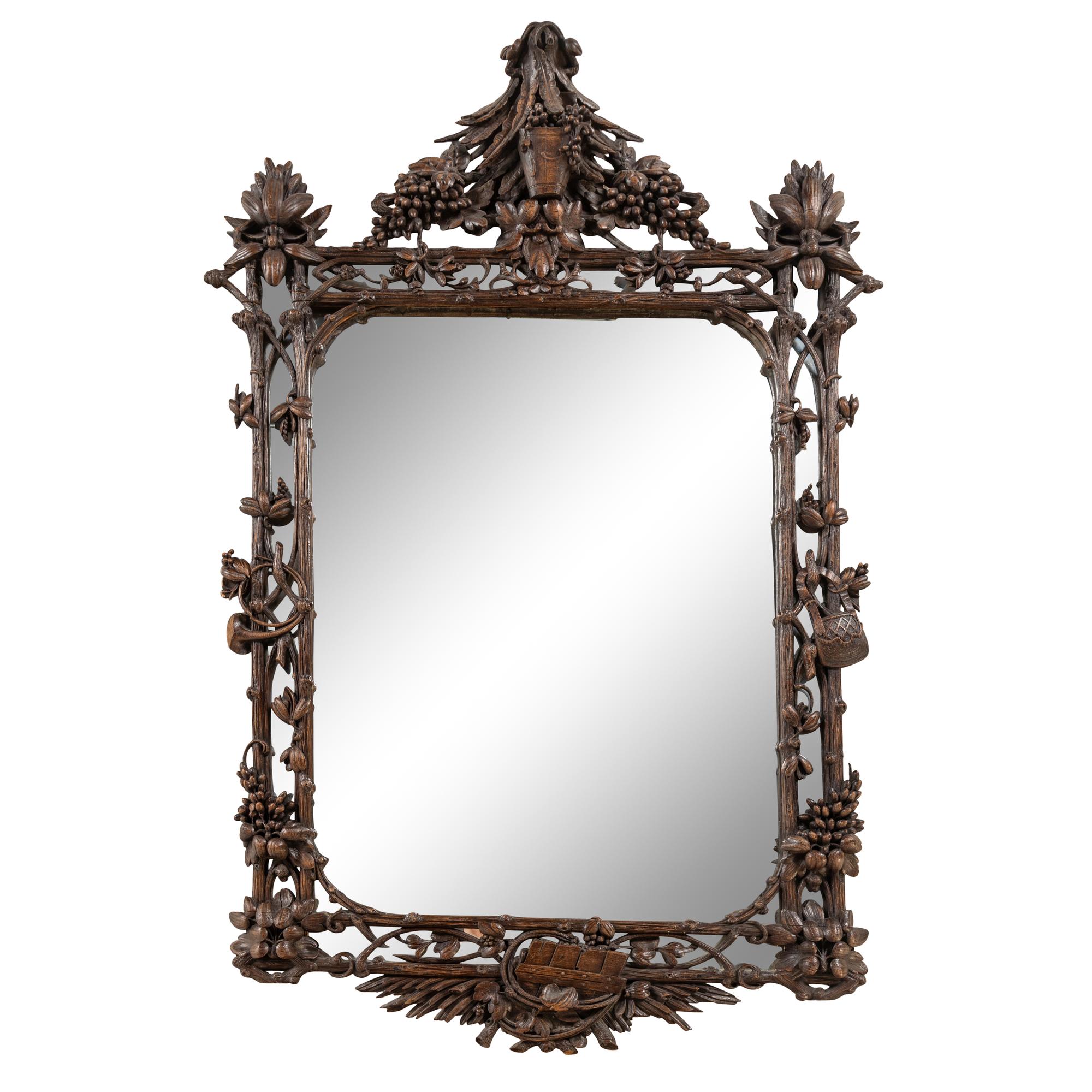A Swiss "Black Forest" Carved Oak Mirror