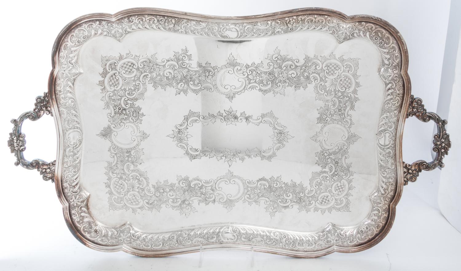 A Group of Silver-Plate Serving Trays Width of widest over handles 30 inches.