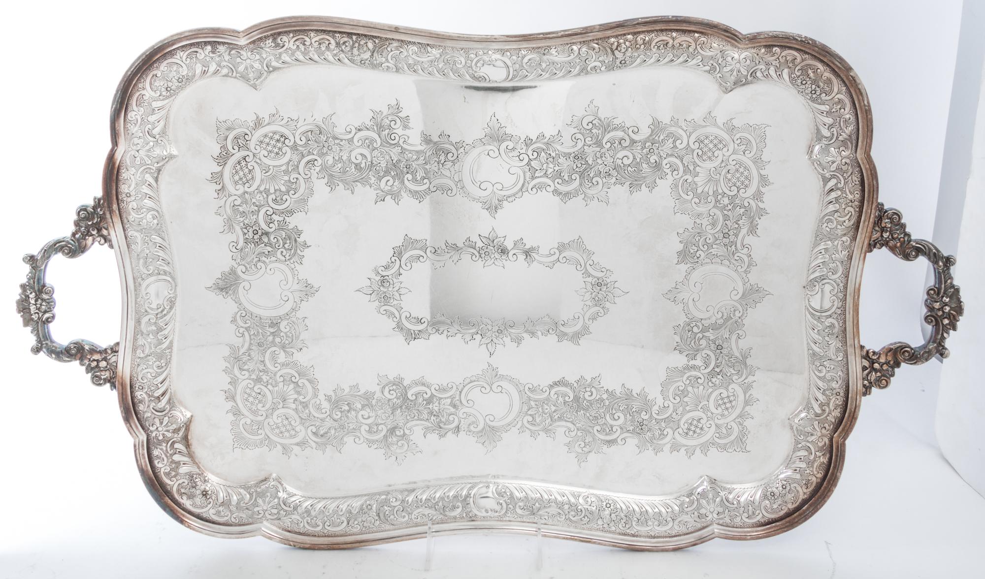 A Group of Silver-Plate Serving Trays Width of widest over handles 30 inches.