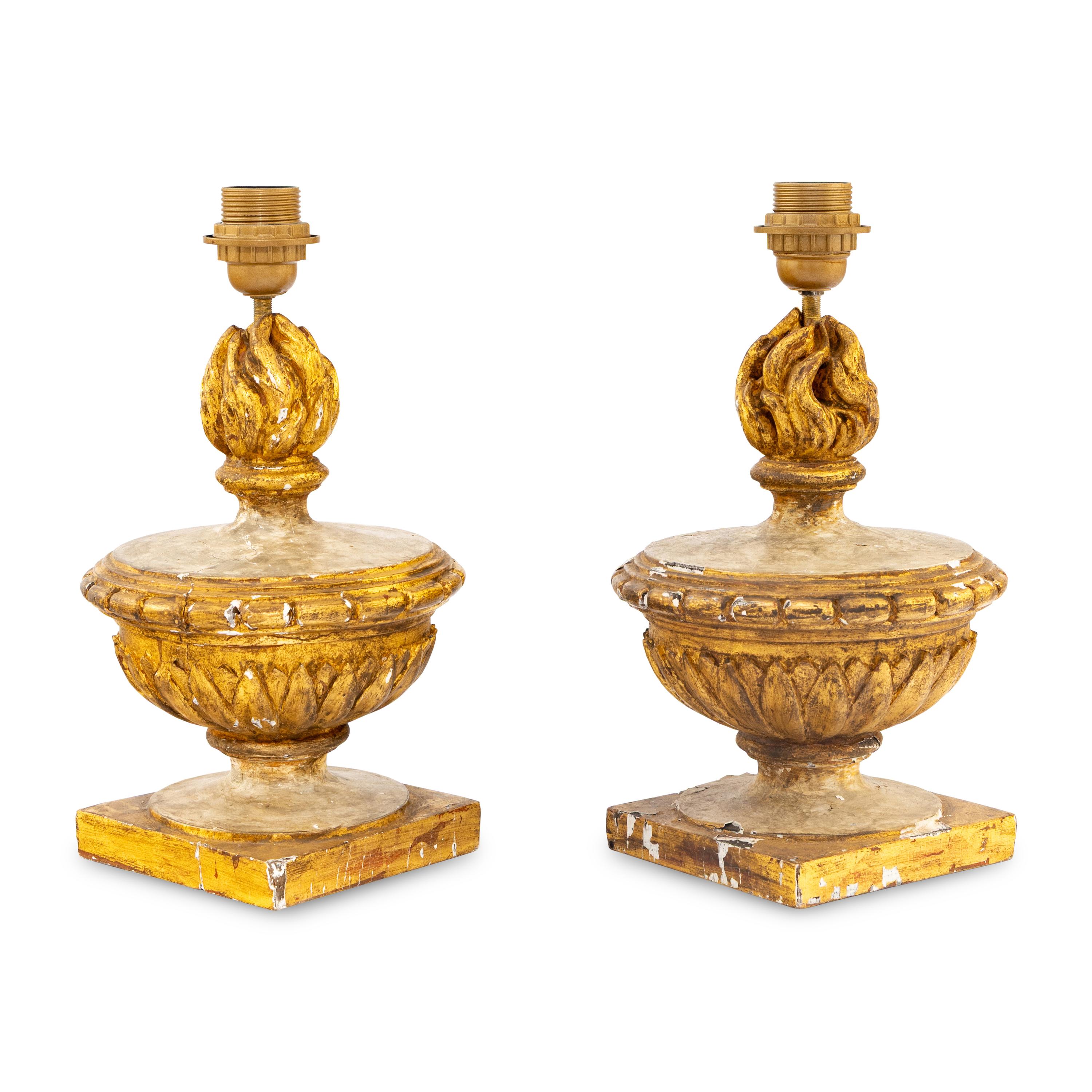 A Pair of Neoclassical Painted and Parcel-Gilt Wood Flaming Urn Finials