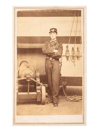 [CIVIL WAR]. CDV of a Naval ensign standing beside cannon. Newport, RI: F. Kindler, ca 1864-1865.