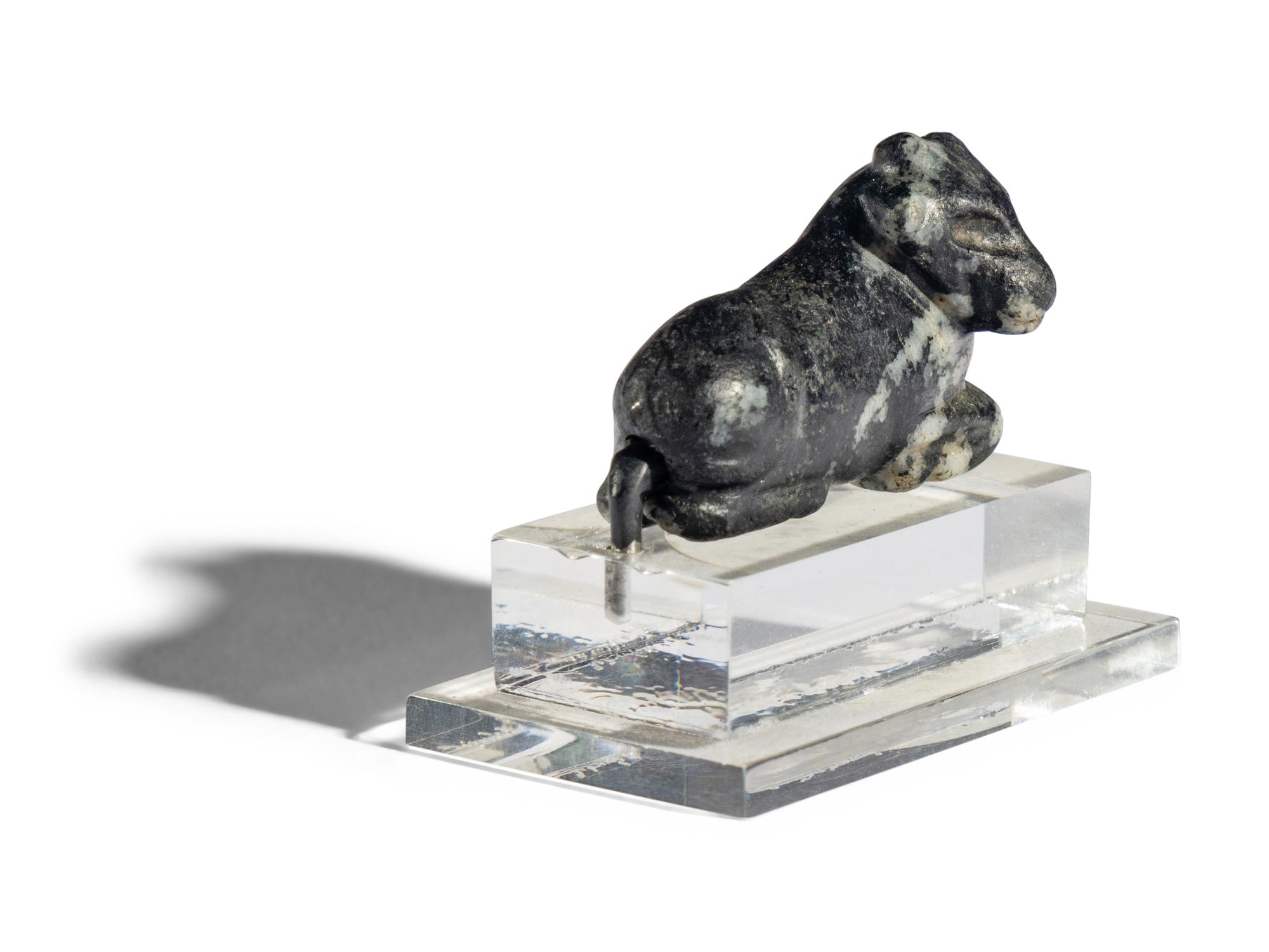 A Mesopotamian Mottled Black Stone Recumbent Bull Amulet