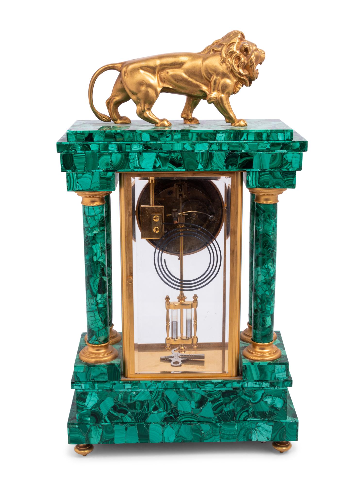An Empire Style Gilt Metal and Malachite Veneered “Crystal Regulator" Clock