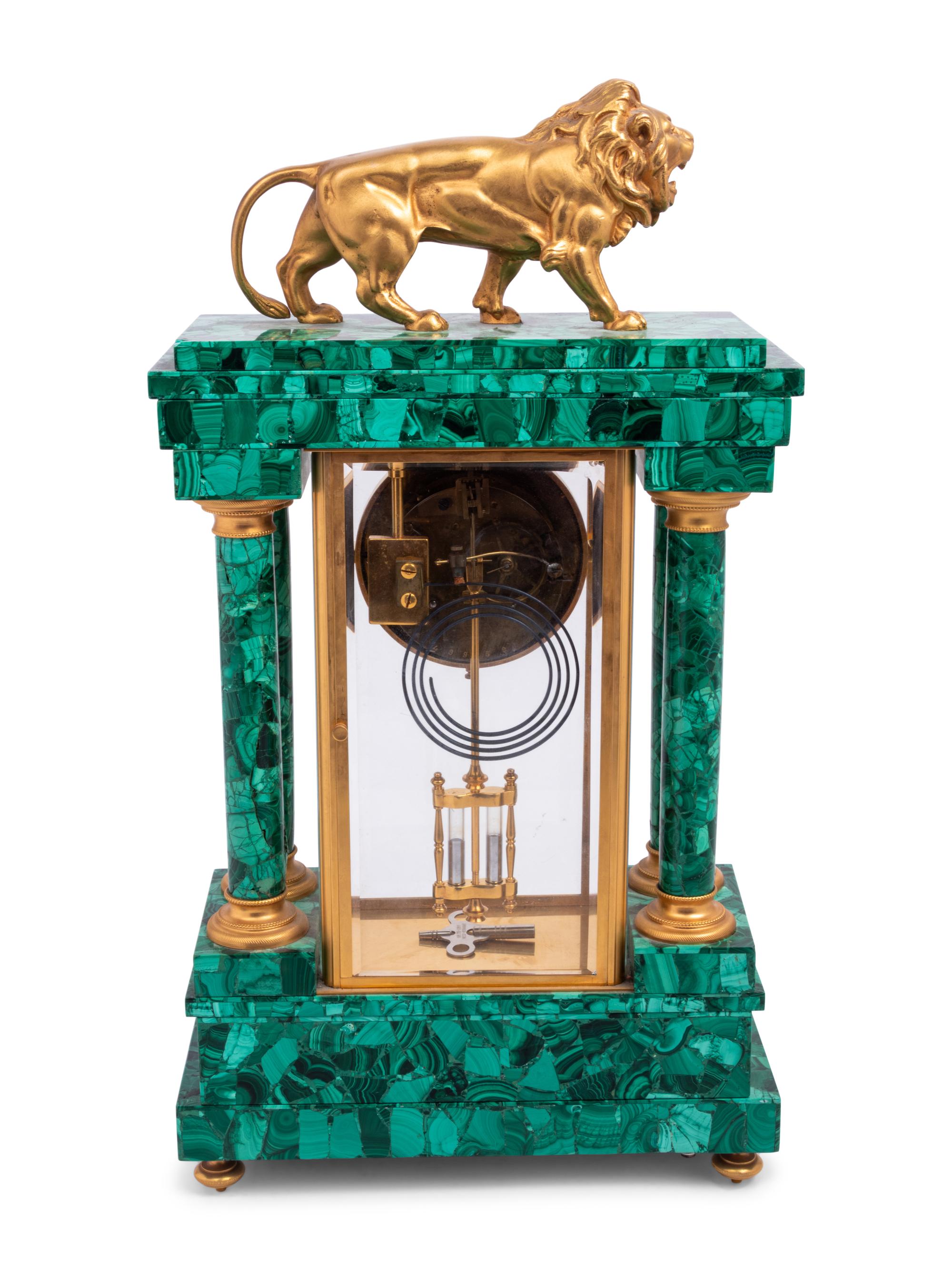 An Empire Style Gilt Metal and Malachite Veneered “Crystal Regulator" Clock