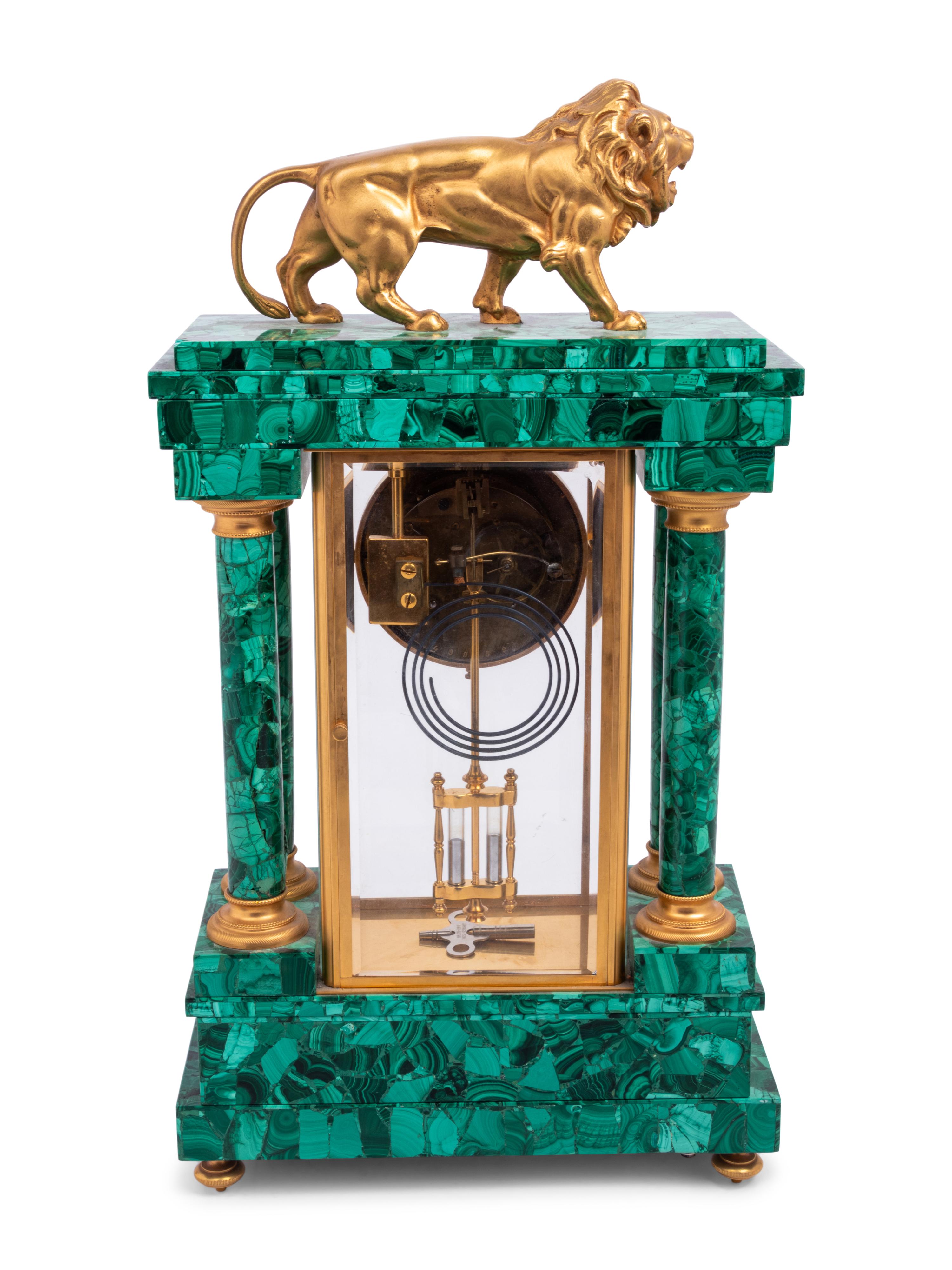 An Empire Style Gilt Metal and Malachite Veneered “Crystal Regulator" Clock
