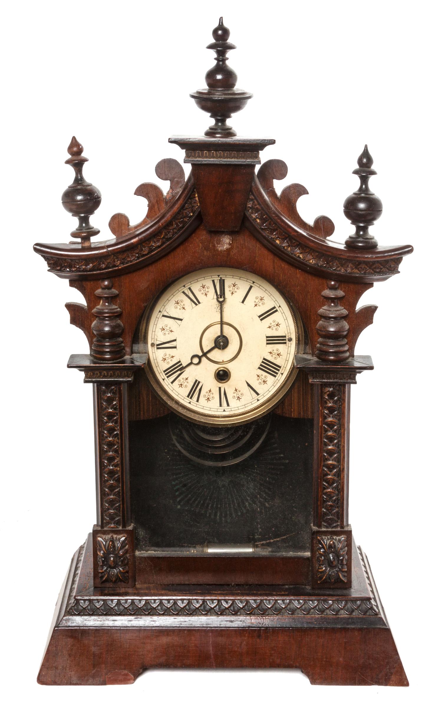A Victorian Walnut Bracket Clock Height 18 3/4 inches.