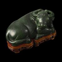 A Chinese Spinach Jade Buffalo, Qing Dynasty 清 青玉臥牛
