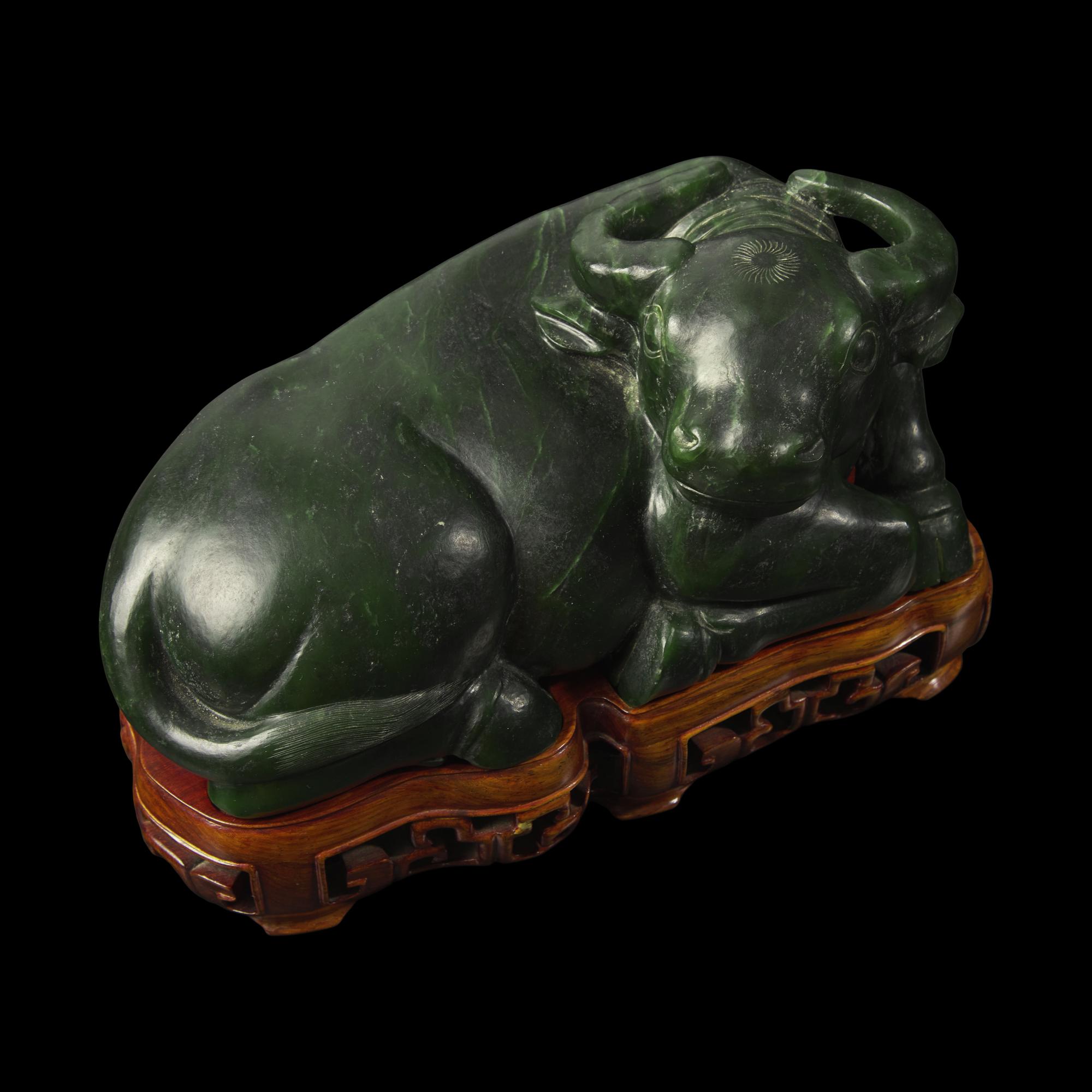 A Chinese Spinach Jade Buffalo, Qing Dynasty 清 青玉臥牛