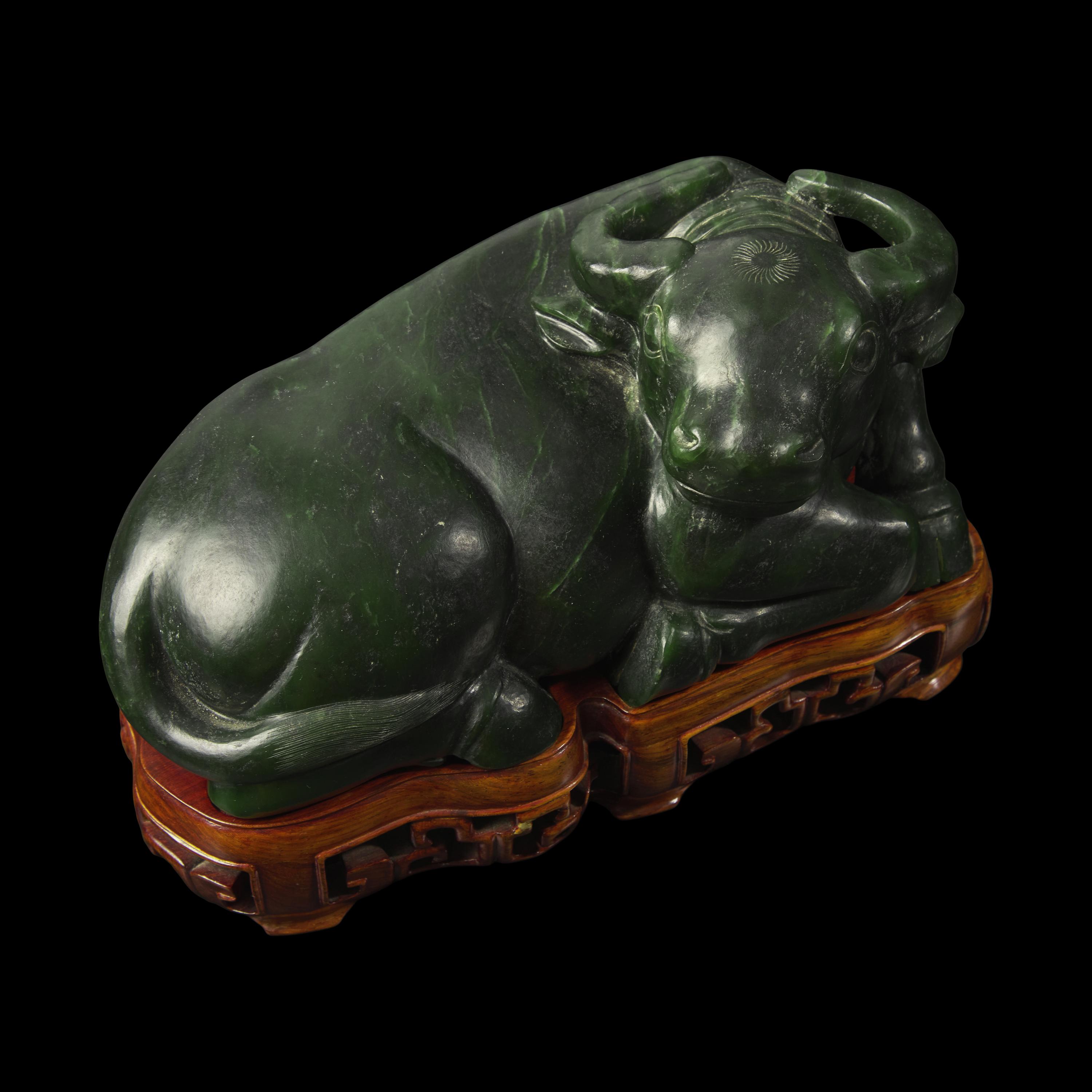 A Chinese Spinach Jade Buffalo, Qing Dynasty 清 青玉臥牛