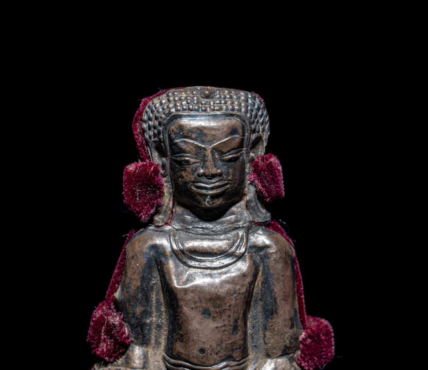 A Thai Silvered Metal Repoussé Plaque of Buddha