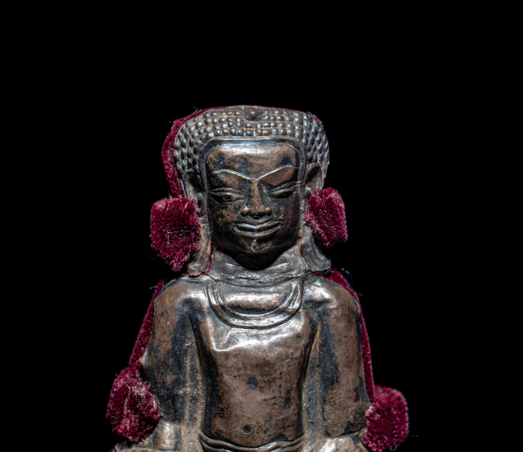 A Thai Silvered Metal Repoussé Plaque of Buddha