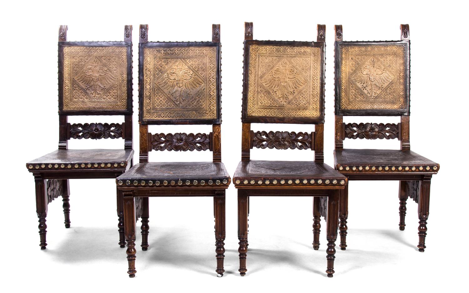A Pair of Continental Carved Walnut and Leather Side Chairs, Height of first pair 46 inches.