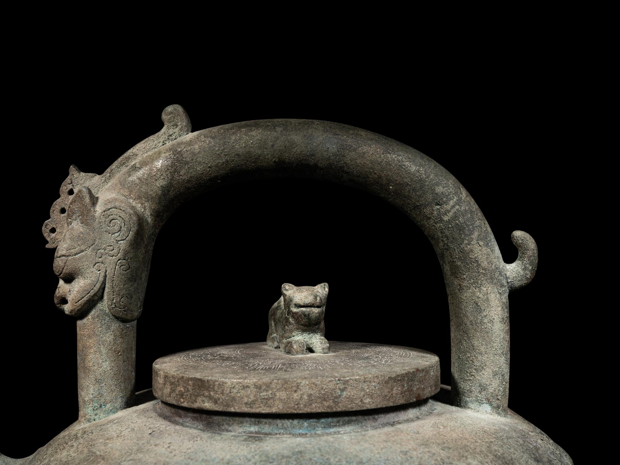 An Archaic Bronze Tripod Wine Vessel, He