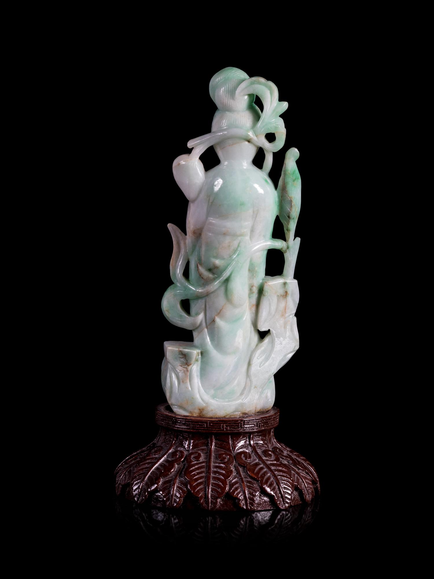An Apple Green and White Jadeite Figure of a Lady Immortal